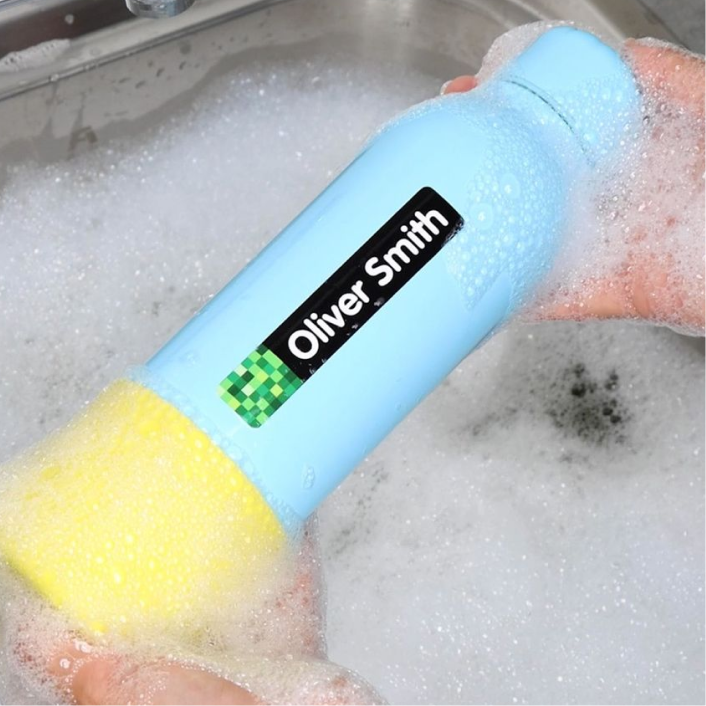Labelled bottle being washed in soapy water
