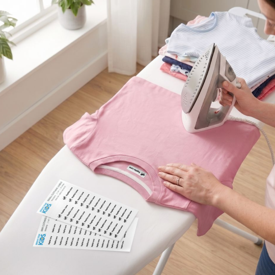 Iron-on clothing label being applied to fabric with a household iron