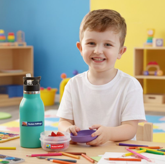 Child eating lunch with labelled bottle and lunch box
