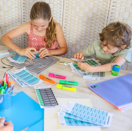 Primary school children applying name labels