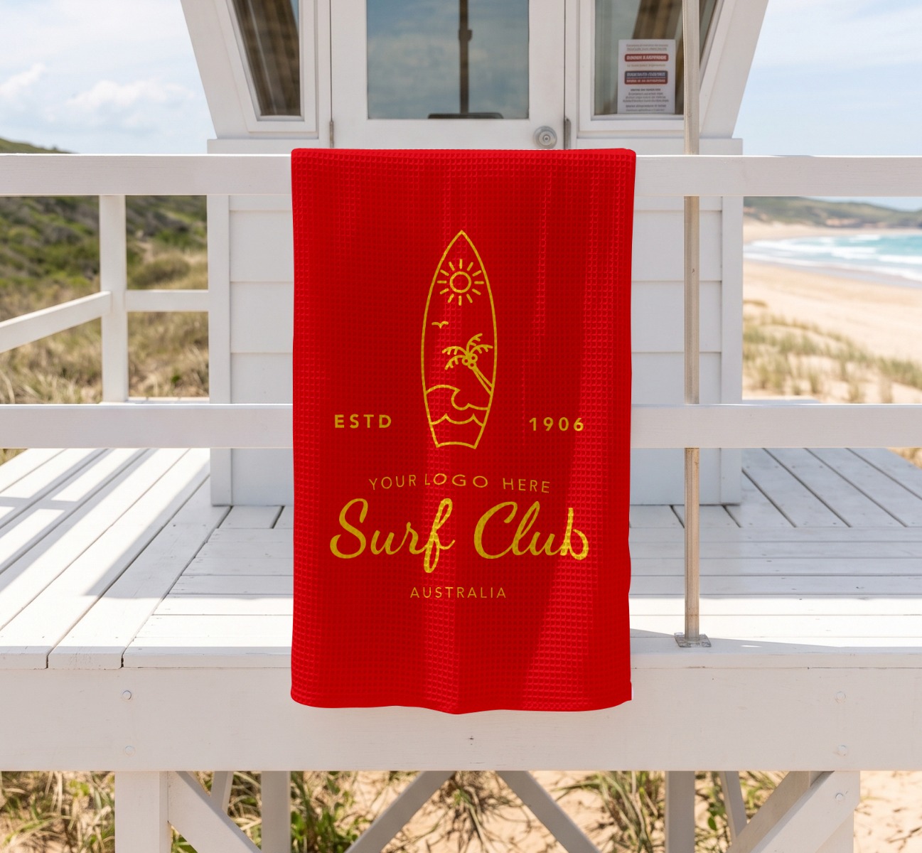 Personalised towel hanging over life-guard hut.
